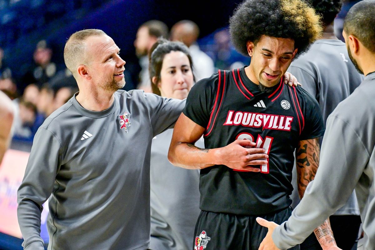 Feb 16, 2025; South Bend, Indiana, USA; Louisville Cardinals head coach Pat Kelsey talks to guard Chucky Hepburn (24) after he left the game against the Notre Dame Fighting Irish at the Purcell Pavilion. Louisville won 75-60. Mandatory Credit: Matt Cashore-Imagn Images