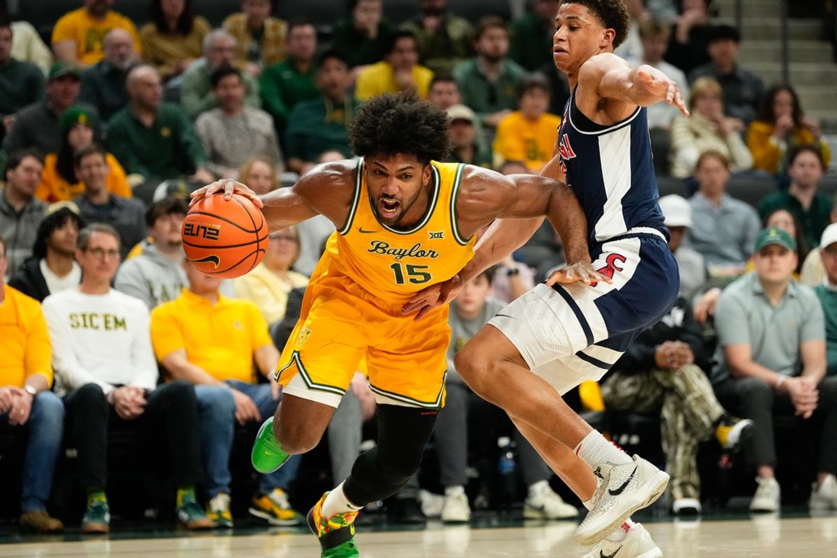 Feb 17, 2025; Waco, Texas, USA;  Baylor Bears forward Norchad Omier (15) drives to the basket past Arizona Wildcats forward Carter Bryant (9) during the first half at Paul and Alejandra Foster Pavilion. Mandatory Credit: Chris Jones-Imagn Images