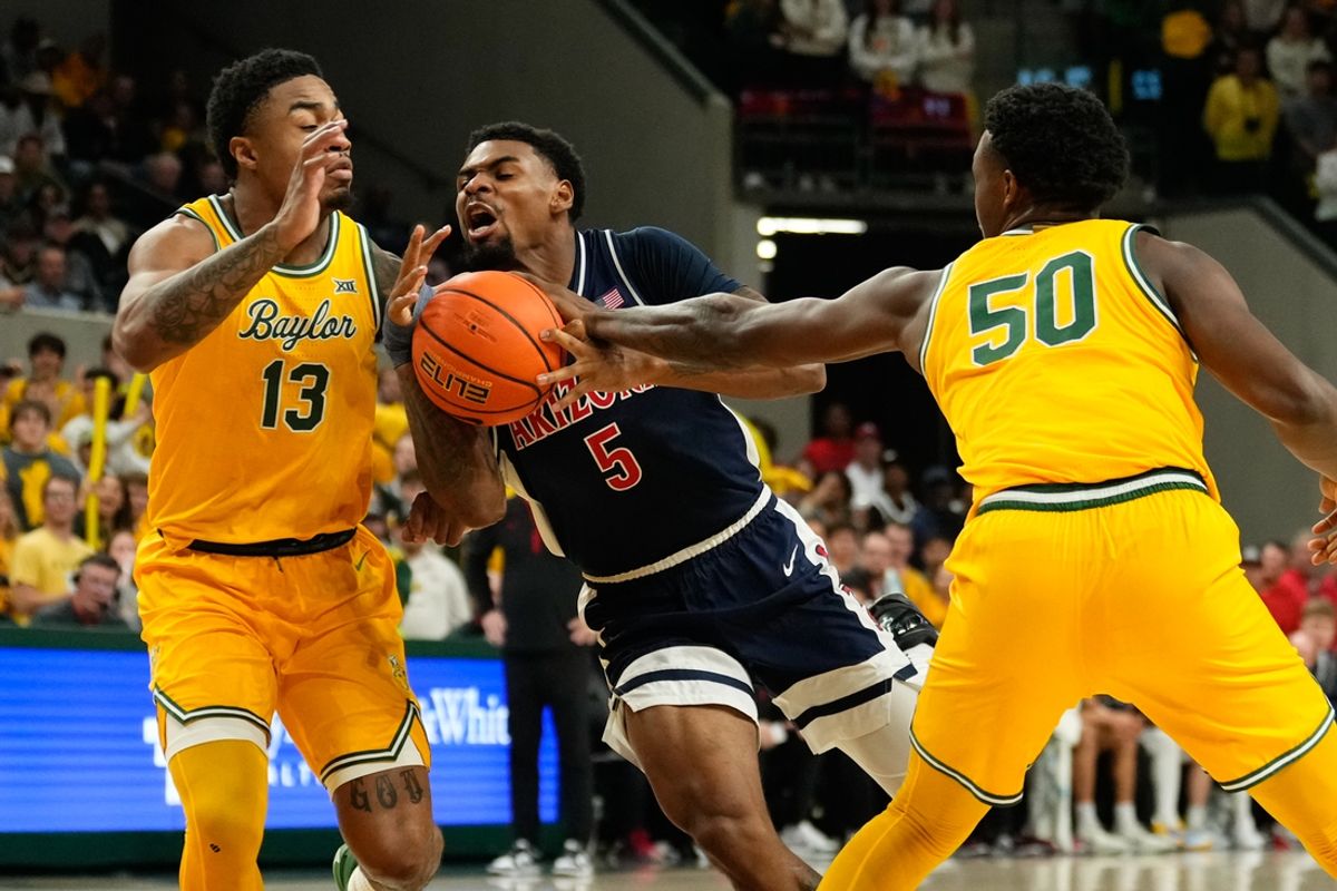 Feb 17, 2025; Waco, Texas, USA;  Arizona Wildcats guard KJ Lewis (5) drives to the basket between Baylor Bears guard Langston Love (13) and guard Jalen Celestine (50) during the first half at Paul and Alejandra Foster Pavilion. Mandatory Credit: Chris Jones-Imagn Images
