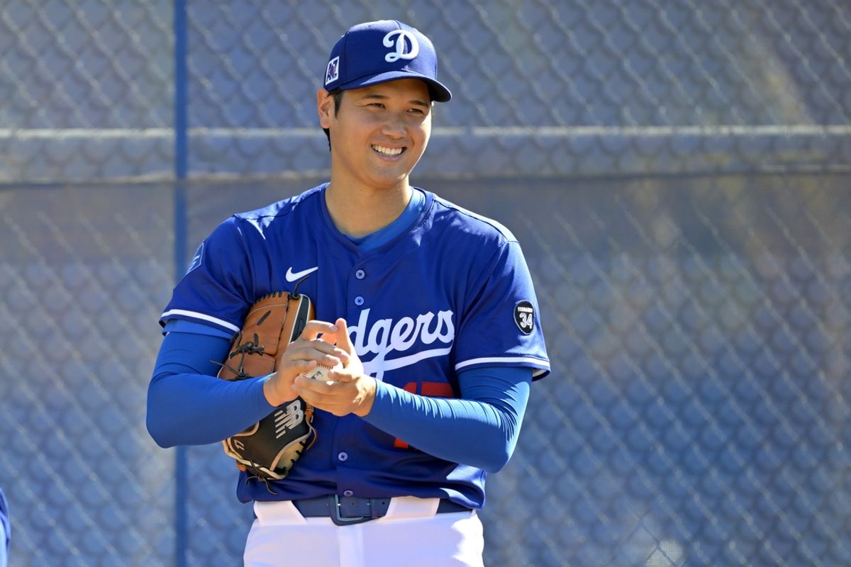 Feb 18, 2025; Glendale, AZ, USA;  Los Angeles Dodgers designated hitter Shohei Ohtani (17) throws a bullpen session during spring training workouts at Camelback Ranch. Mandatory Credit: Jayne Kamin-Oncea-Imagn Images