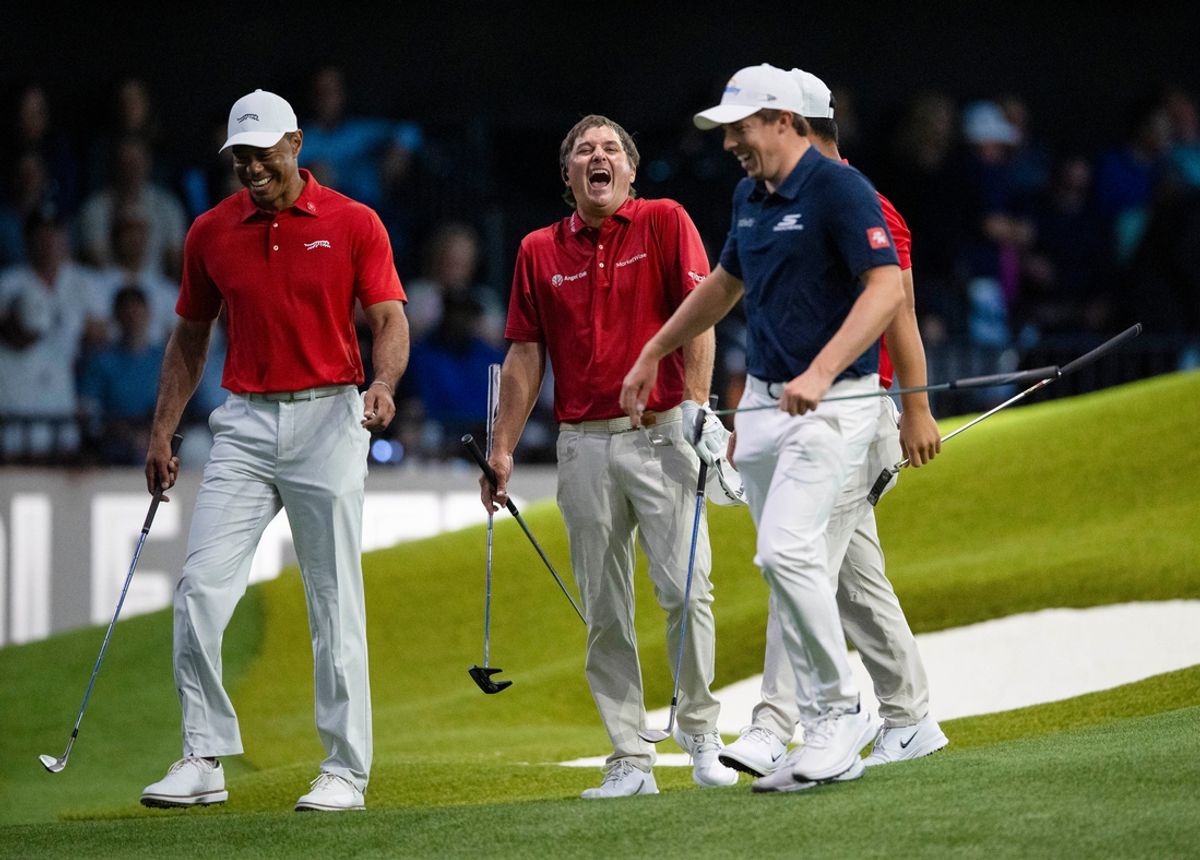 Kevin Kisner, center, laughs after barely missing a putt next to Tiger Woods, left, of Jupiter Links GC and Matt Fitzpatrick of New York Golf Club during a TGL match in SoFi Center at Palm Beach State College on February 18, 2025, in Palm Beach Gardens, Florida.