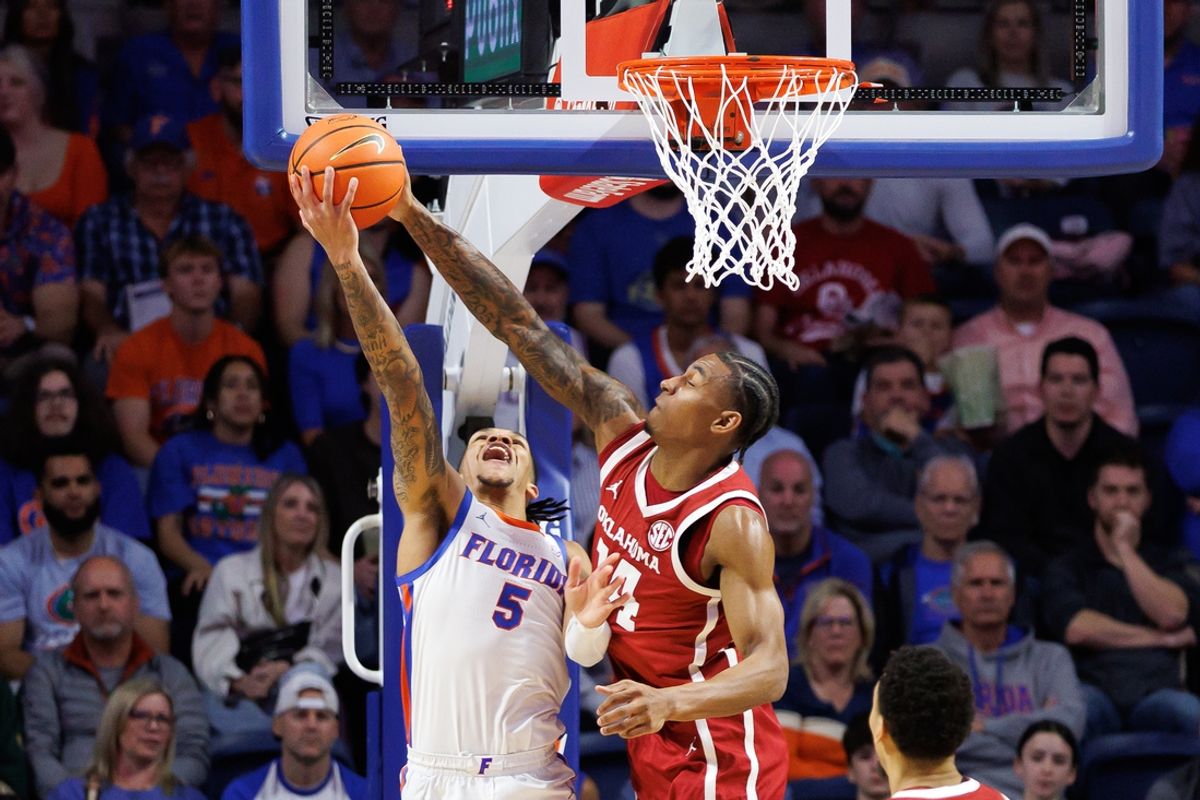 Feb 18, 2025; Gainesville, Florida, USA; Oklahoma Sooners forward Jalon Moore (14) blocks a layup from Florida Gators guard Will Richard (5) during the first half at Exactech Arena at the Stephen C. O'Connell Center. Mandatory Credit: Matt Pendleton-Imagn Images