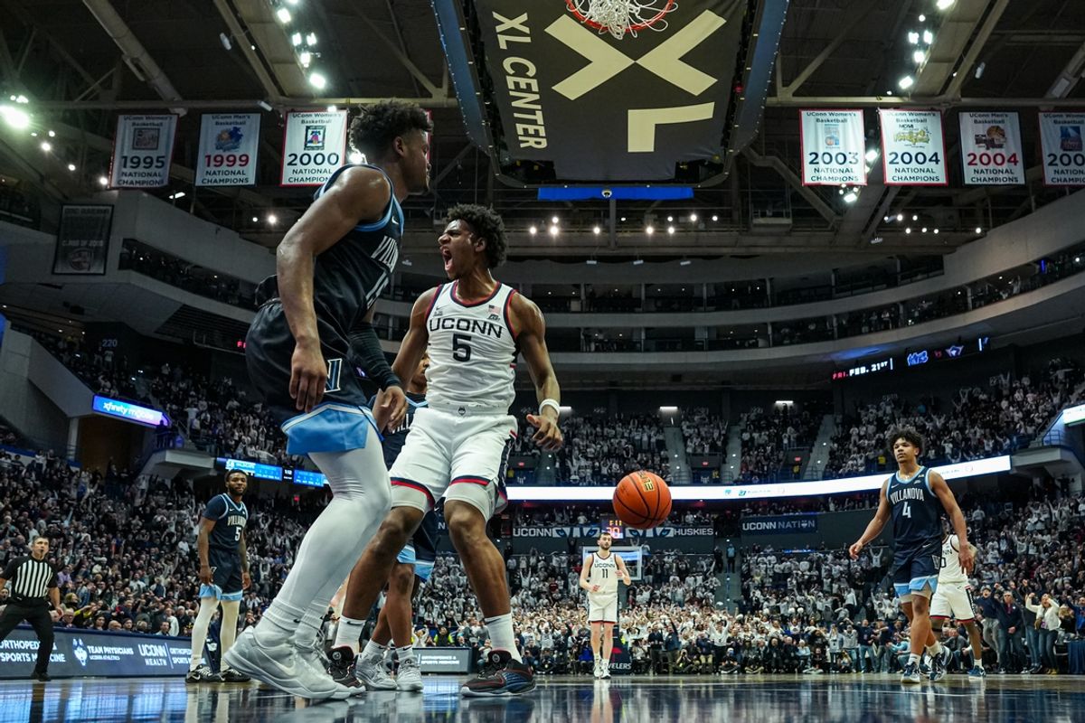 Feb 18, 2025; Hartford, Connecticut, USA; UConn Huskies center Tarris Reed Jr. (5) makes the basket against Villanova Wildcats guard Jordan Longino (15) in the second half at XL Center. Mandatory Credit: David Butler II-Imagn Images