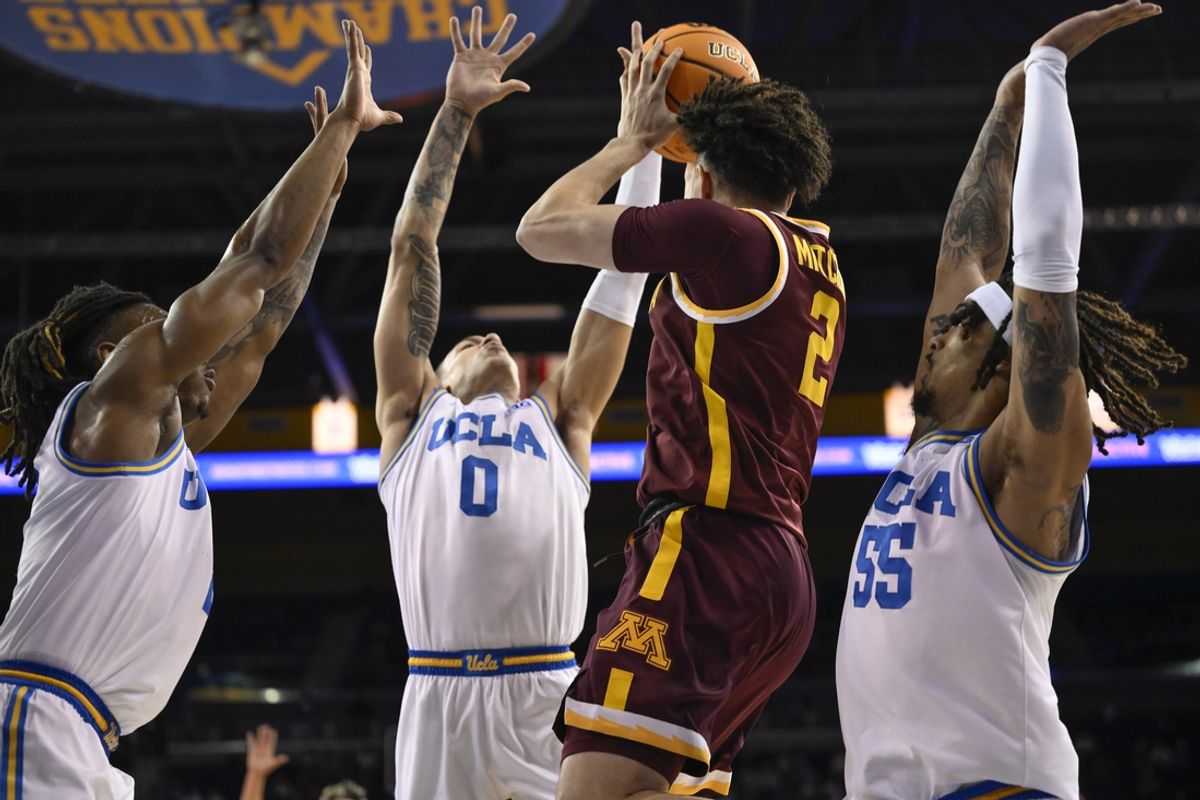 Feb 18, 2025; Los Angeles, California, USA; UCLA Bruins Dylan Andrews (2), Kobe Johnson (0) and Skyy Clark (55) triple team Minnesota Golden Gophers guard Mike Mitchell Jr. (2) during the first half at Pauley Pavilion presented by Wescom. Mandatory Credit: Robert Hanashiro-Imagn Images