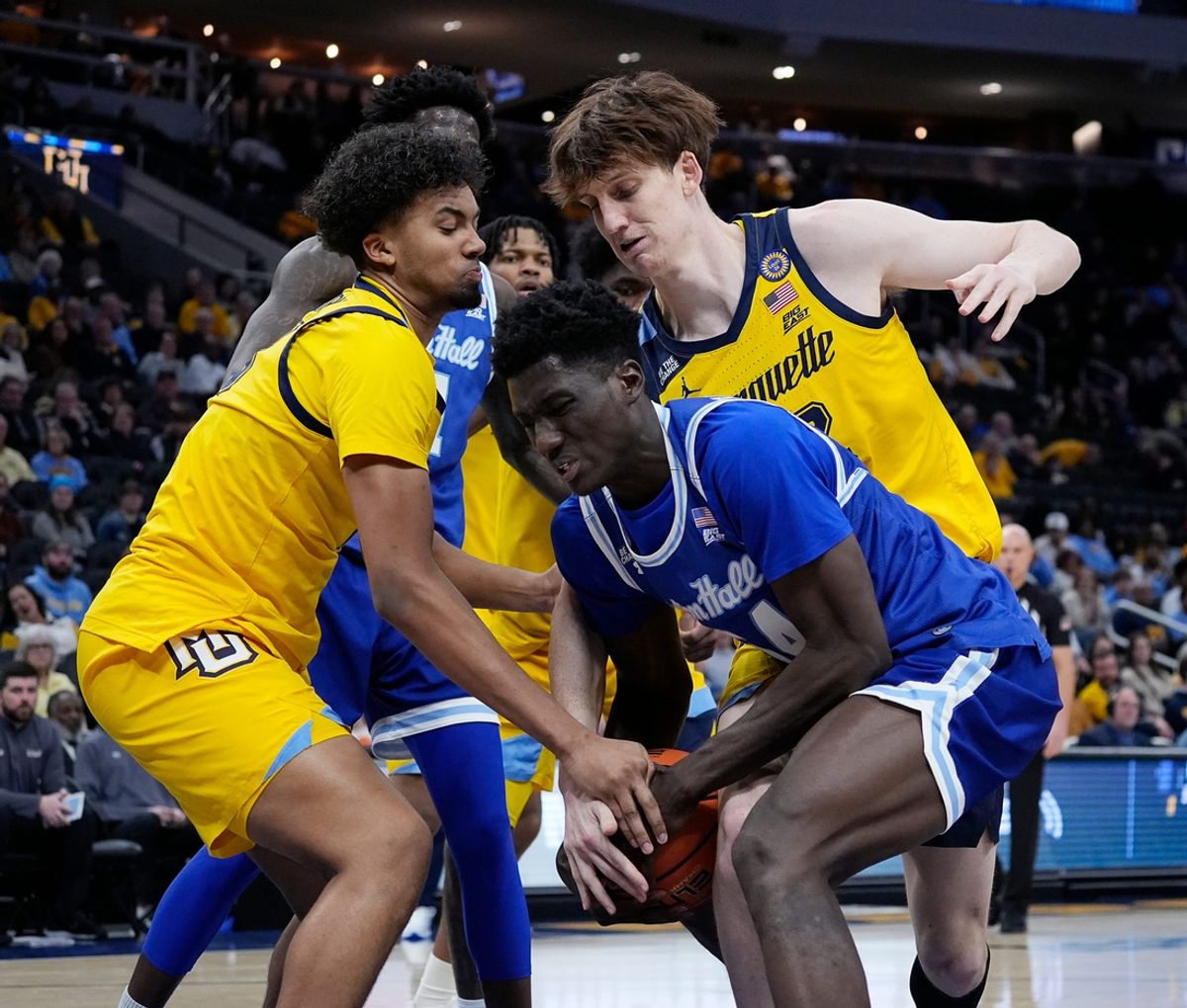 Marquette Golden Eagles forward Royce Parham (13) and forward Ben Gold (12) attempt to steal the ball from Seton Hall Pirates center Godswill Erheriene (54) during the second half of the game on Tuesday February 18, 2025 at Fiserv Forum in Milwaukee, Wis.