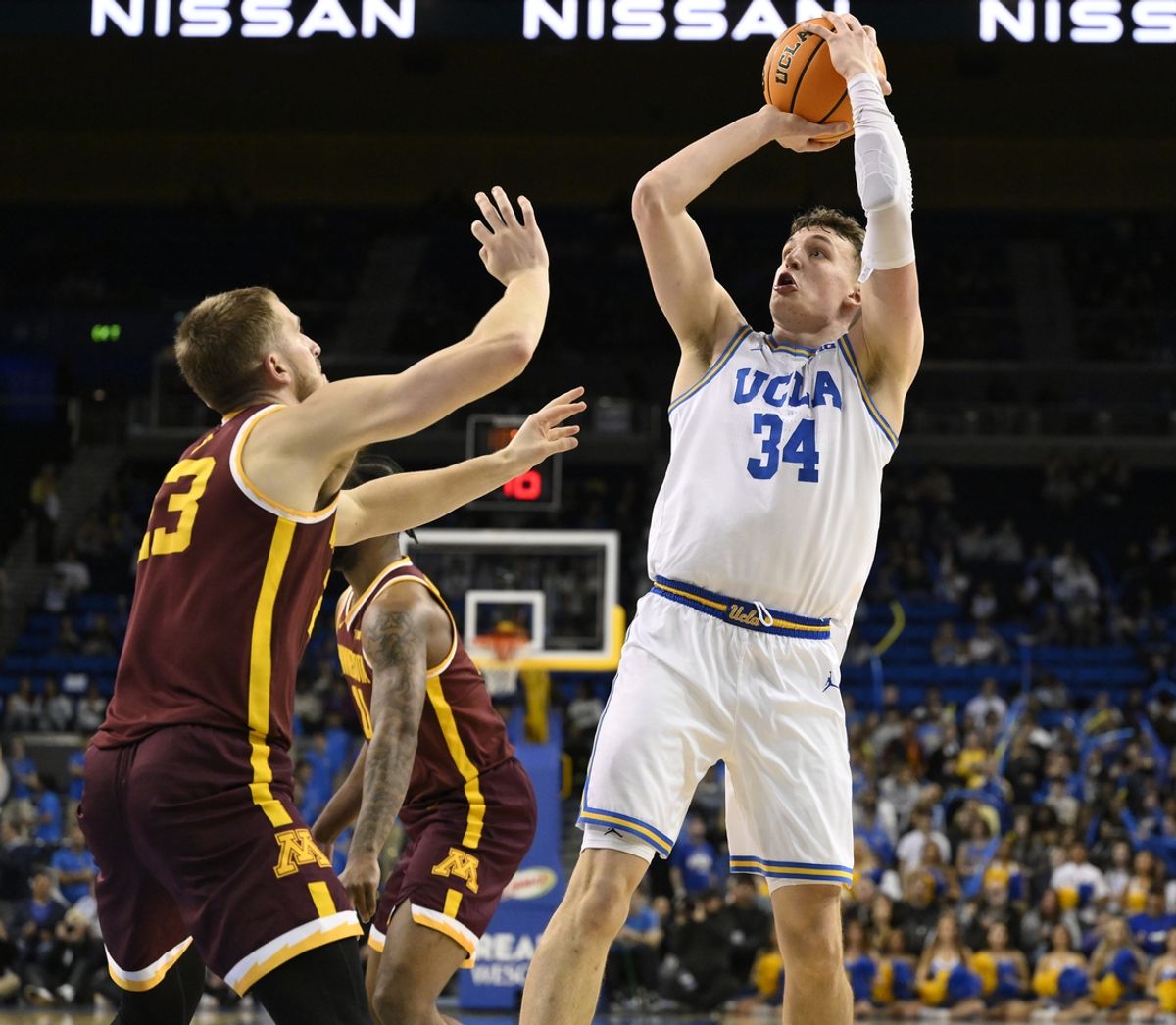 Feb 18, 2025; Los Angeles, California, USA; UCLA Bruins forward Tyler Bilodeau (34) shoots over Minnesota Golden Gophers forward Parker Fox (23) during the second half at Pauley Pavilion presented by Wescom. Mandatory Credit: Robert Hanashiro-Imagn Images