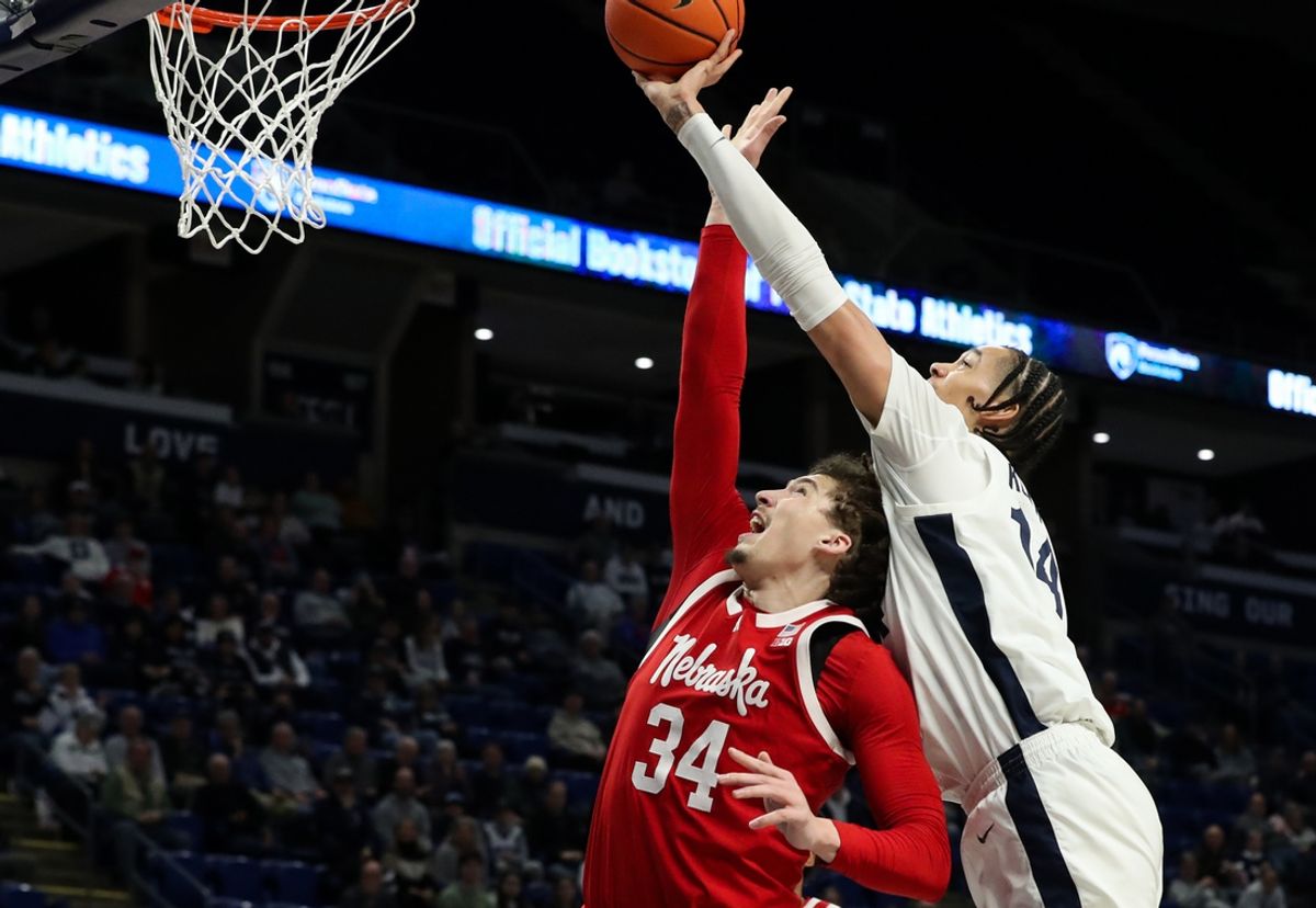 Feb 19, 2025; University Park, Pennsylvania, USA; Penn State Nittany Lions forward Yanic Konan Niederhauser (14) attempts to tip the ball into the basket during the first half against the Nebraska Cornhuskers at Bryce Jordan Center. Mandatory Credit: Matthew O'Haren-Imagn Images