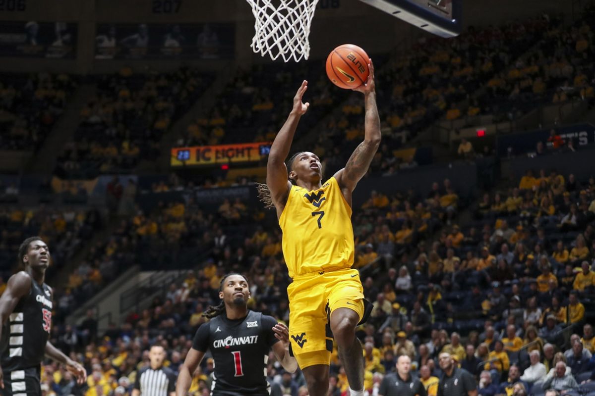 Feb 19, 2025; Morgantown, West Virginia, USA; West Virginia Mountaineers guard Javon Small (7) shoots a layup during the first half against the Cincinnati Bearcats at WVU Coliseum. Mandatory Credit: Ben Queen-Imagn Images