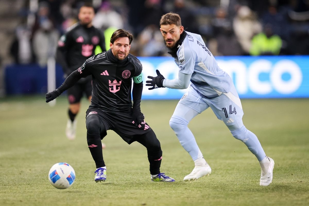 Feb 19, 2025; Kansas City, Kansas, USA; Inter Miami forward Lionel Messi (10) and Sporting Kansas City defender Tim Leibold (14) go after the ball during the first half at Children's Mercy Park. Mandatory Credit: William Purnell-Imagn Images