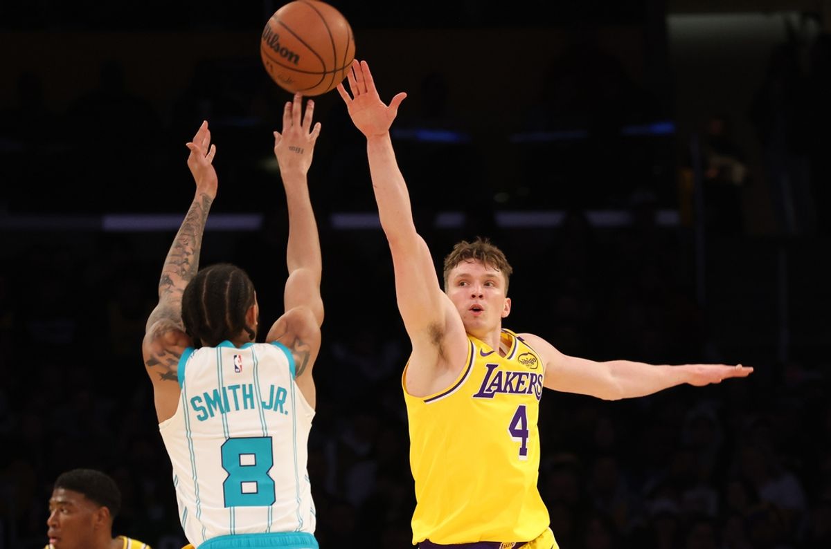 Feb 19, 2025; Los Angeles, California, USA; Charlotte Hornets guard Nick Smith Jr. (8) shoots against Los Angeles Lakers guard Dalton Knecht (4) during the second quarter at Crypto.com Arena. Mandatory Credit: Jason Parkhurst-Imagn Images