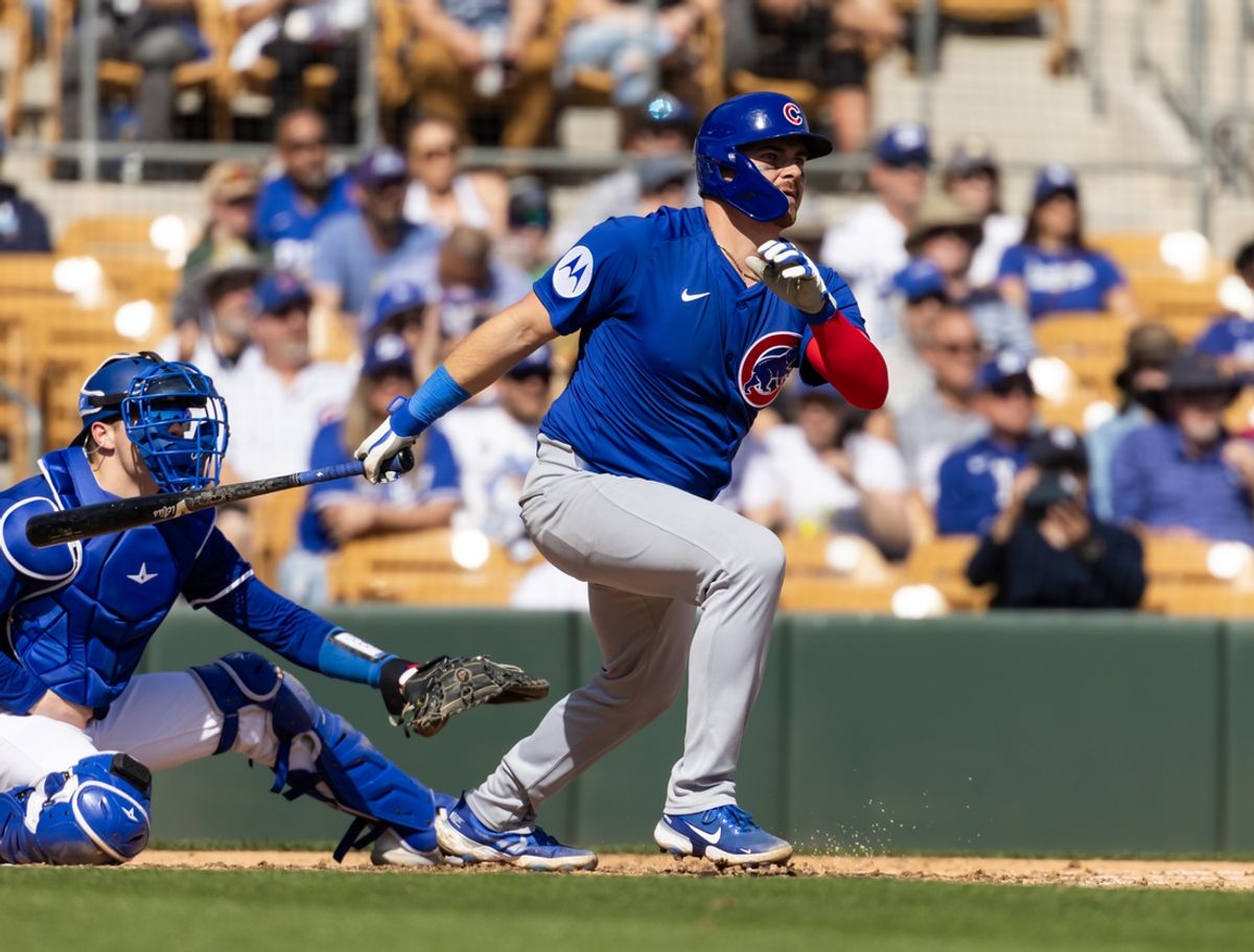 Feb 20, 2025; Phoenix, Arizona, USA; Chicago Cubs catcher Reese McGuire hits a two run double against the Los Angeles Dodgers during a spring training game at Camelback Ranch-Glendale. Mandatory Credit: Mark J. Rebilas-Imagn Images