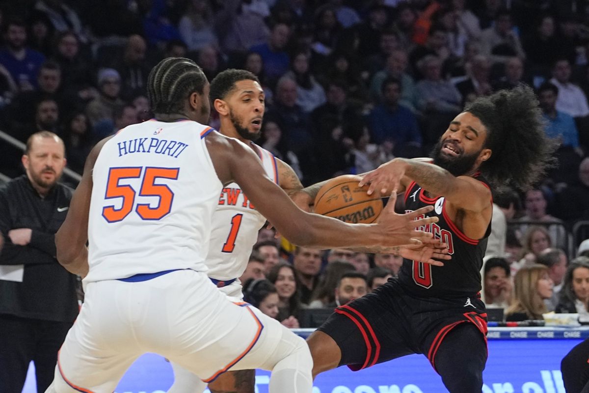 Feb 20, 2025; New York, New York, USA; Chicago Bulls point guard Coby White (0) and New York Knicks point guard Cameron Payne (1) and center Ariel Hukporti (55) battle for a rebound during the first half at Madison Square Garden. Mandatory Credit: Gregory Fisher-Imagn Images
