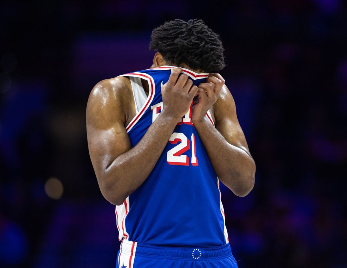 Feb 20, 2025; Philadelphia, Pennsylvania, USA; Philadelphia 76ers center Joel Embiid (21) wipes his face during a break in the third quarter against the Boston Celtics at Wells Fargo Center. Mandatory Credit: Bill Streicher-Imagn Images