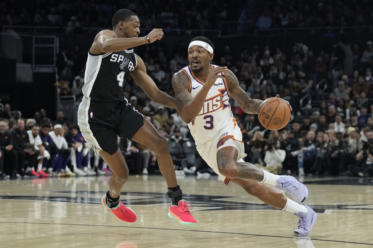 Feb 20, 2025; Austin, Texas, USA; Phoenix Suns guard Bradley Beal (3) drives to the basket against San Antonio Spurs guard De'Aron Fox (4) during the first half at Moody Center. Mandatory Credit: Scott Wachter-Imagn Images