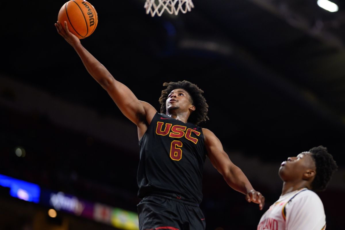 Feb 20, 2025; College Park, Maryland, USA; USC Trojans guard Wesley Yates III (6) drives to the basket against Maryland Terrapins center Derik Queen (25) during the first half at Xfinity Center. Mandatory Credit: Reggie Hildred-Imagn Images