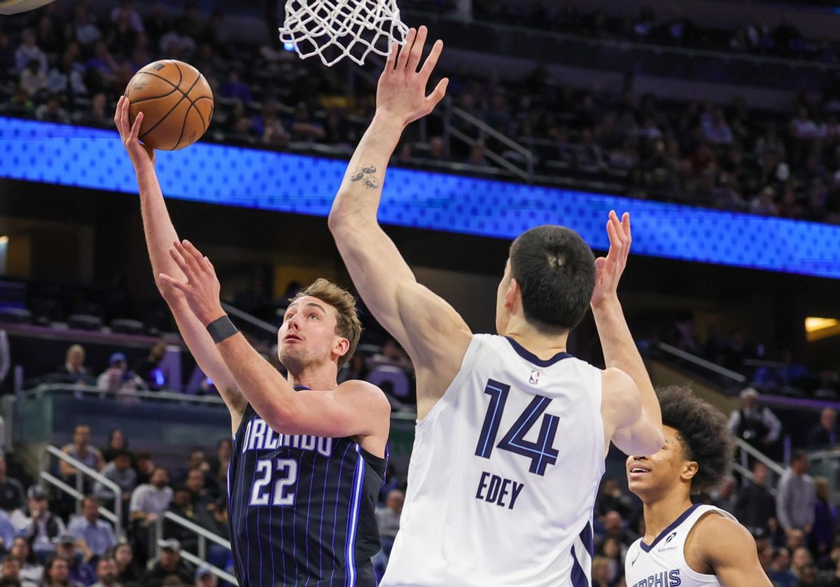 Feb 21, 2025; Orlando, Florida, USA; Orlando Magic forward Franz Wagner (22) goes to the basket against Memphis Grizzlies center Zach Edey (14) during the first quarter at Kia Center. Mandatory Credit: Mike Watters-Imagn Images