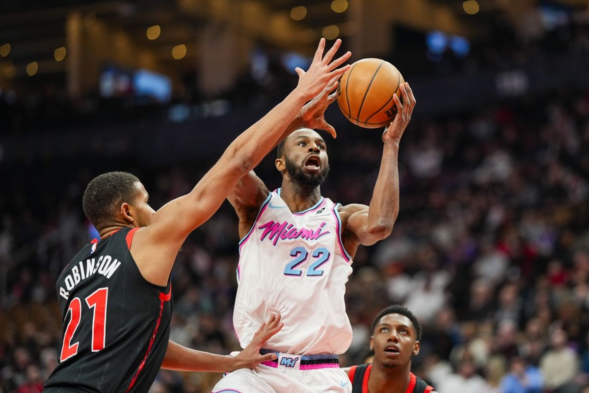 Feb 21, 2025; Toronto, Ontario, CAN; Miami Heat forward Andrew Wiggins (22) drives to the basket against Toronto Raptors center Orlando Robinson (21) during the first half at Scotiabank Arena. Mandatory Credit: Kevin Sousa-Imagn Images