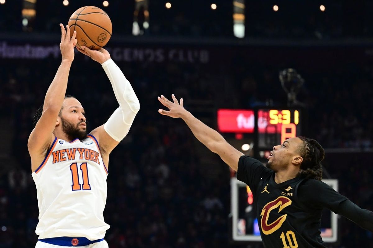 Feb 21, 2025; Cleveland, Ohio, USA;  New York Knicks guard Jalen Brunson (11) shoots over the defense of Cleveland Cavaliers guard Darius Garland (10) during the first half at Rocket Arena. Mandatory Credit: Ken Blaze-Imagn Images