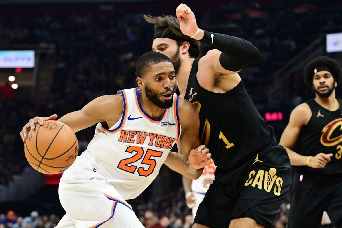 Feb 21, 2025; Cleveland, Ohio, USA;  New York Knicks forward Mikal Bridges (25) drives to the basket against Cleveland Cavaliers guard Max Strus (1) during the first half at Rocket Arena. Mandatory Credit: Ken Blaze-Imagn Images