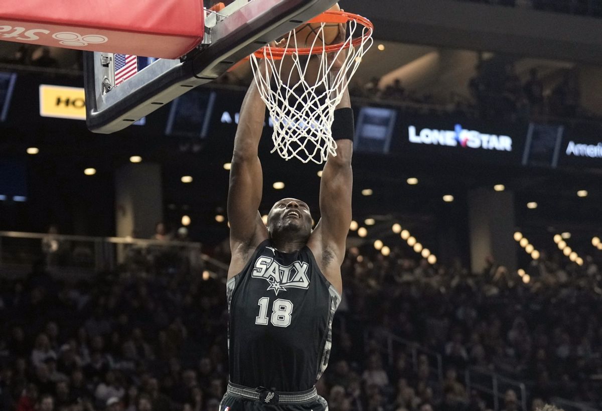 Feb 21, 2025; Austin, Texas, USA; San Antonio Spurs center Bismack Biyombo (18) dunks during the first half against the Detroit Pistons at Moody Center. Mandatory Credit: Scott Wachter-Imagn Images