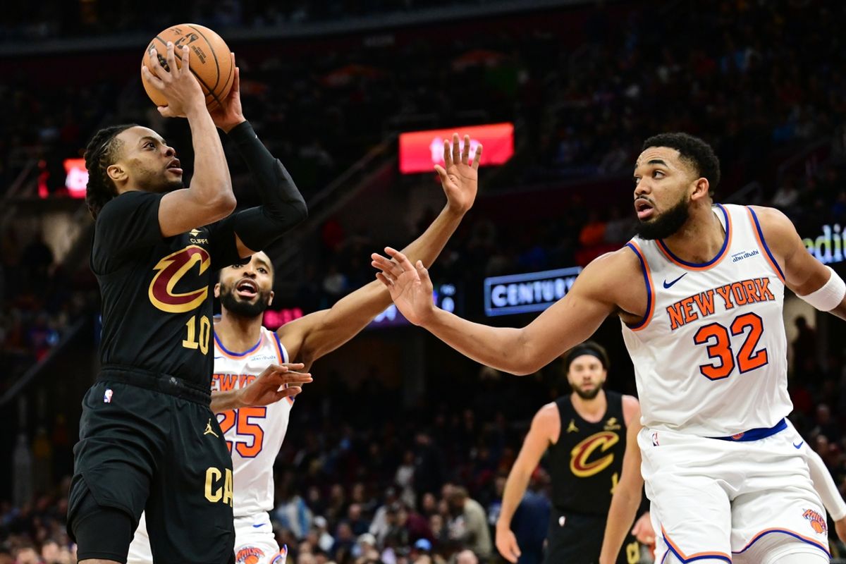 Feb 21, 2025; Cleveland, Ohio, USA;  Cleveland Cavaliers guard Darius Garland (10) shoots as New York Knicks center Karl-Anthony Towns (32) defends during the second half at Rocket Arena. Mandatory Credit: Ken Blaze-Imagn Images