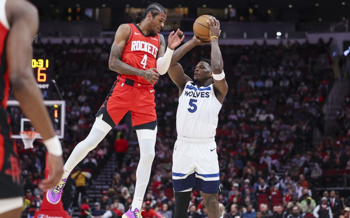 Feb 21, 2025; Houston, Texas, USA; Minnesota Timberwolves guard Anthony Edwards (5) shoots the ball as Houston Rockets guard Jalen Green (4) defends during the first quarter at Toyota Center. Mandatory Credit: Troy Taormina-Imagn Images