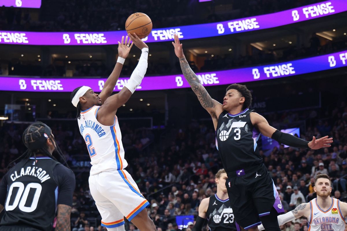 Feb 21, 2025; Salt Lake City, Utah, USA; Oklahoma City Thunder guard Shai Gilgeous-Alexander (2) shoots over Utah Jazz guard Keyonte George (3) during the second quarter at Delta Center. Mandatory Credit: Rob Gray-Imagn Images