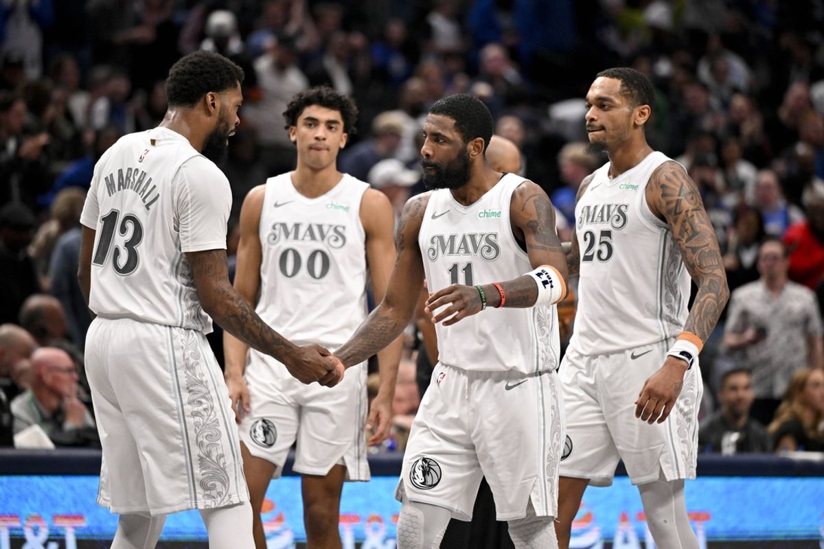 Feb 21, 2025; Dallas, Texas, USA; Dallas Mavericks guard Kyrie Irving (11) and forward Naji Marshall (13) and guard Max Christie (00) and forward P.J. Washington (25) celebrate after Irving makes a three point shot against the New Orleans Pelicans during the second half at the American Airlines Center. Mandatory Credit: Jerome Miron-Imagn Images