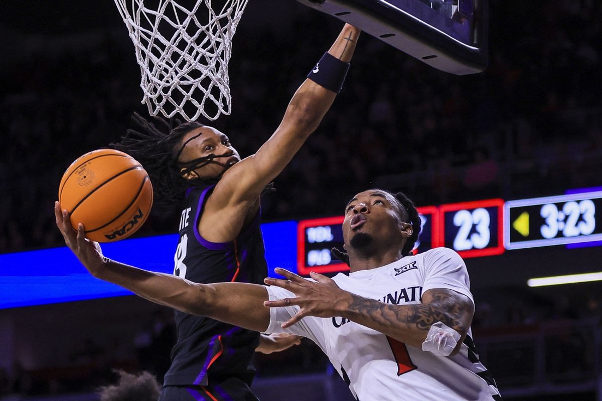 Feb 22, 2025; Cincinnati, Ohio, USA; Cincinnati Bearcats guard Day Day Thomas (1) shoots against TCU Horned Frogs forward Trazarien White (13) in the first half at Fifth Third Arena. Mandatory Credit: Katie Stratman-Imagn Images