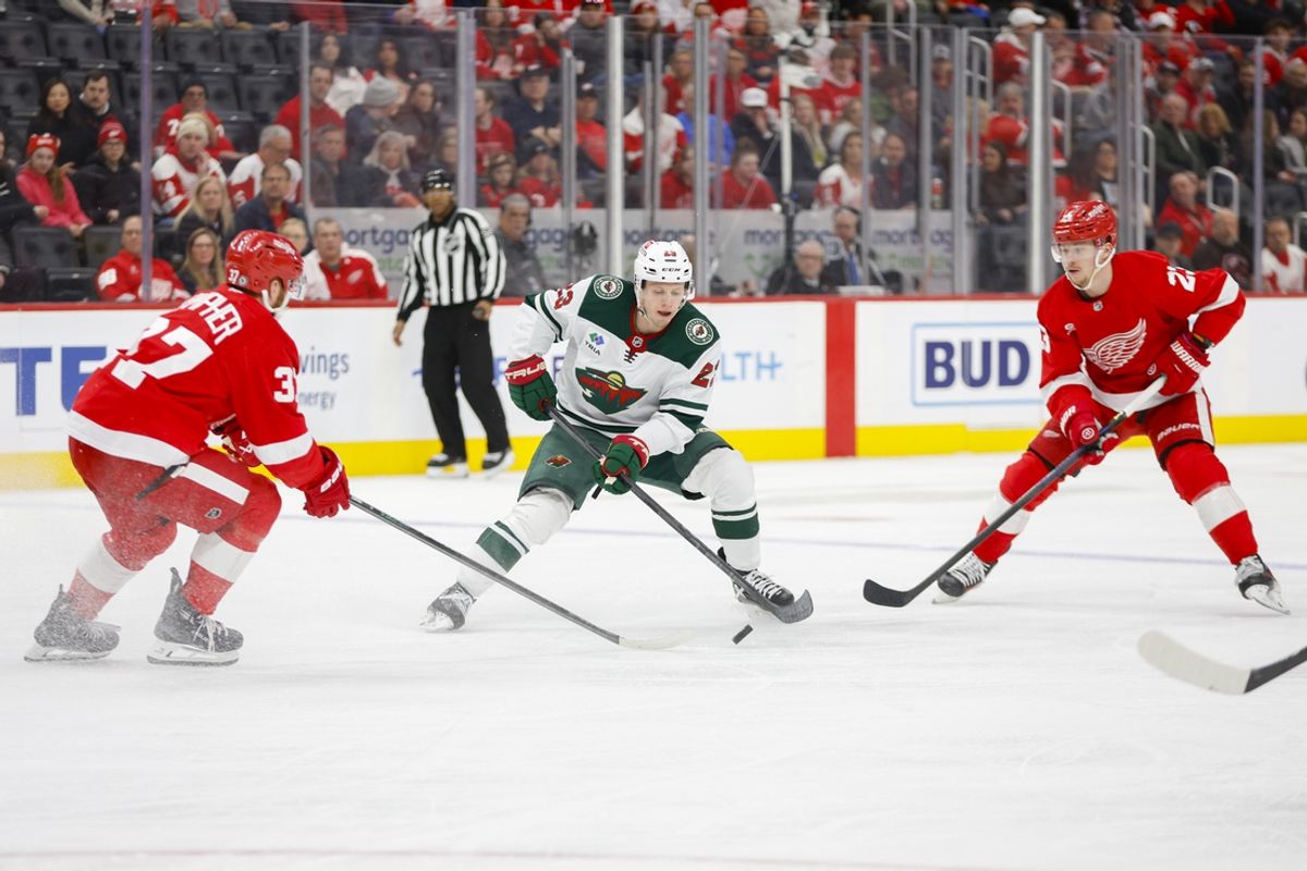 Feb 22, 2025; Detroit, Michigan, USA; Minnesota Wild center Marco Rossi (23) handles the puck during the first period against the Detroit Red Wings at Little Caesars Arena. Mandatory Credit: Brian Bradshaw Sevald-Imagn Images