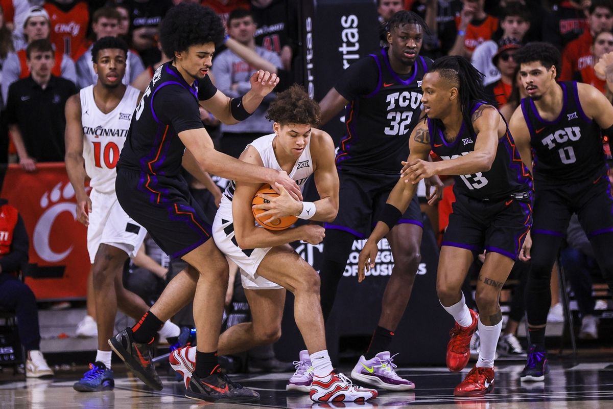 Feb 22, 2025; Cincinnati, Ohio, USA; Cincinnati Bearcats guard Dan Skillings Jr. (0) battles for the ball against TCU Horned Frogs forward David Punch (15) in the second half at Fifth Third Arena. Mandatory Credit: Katie Stratman-Imagn Images