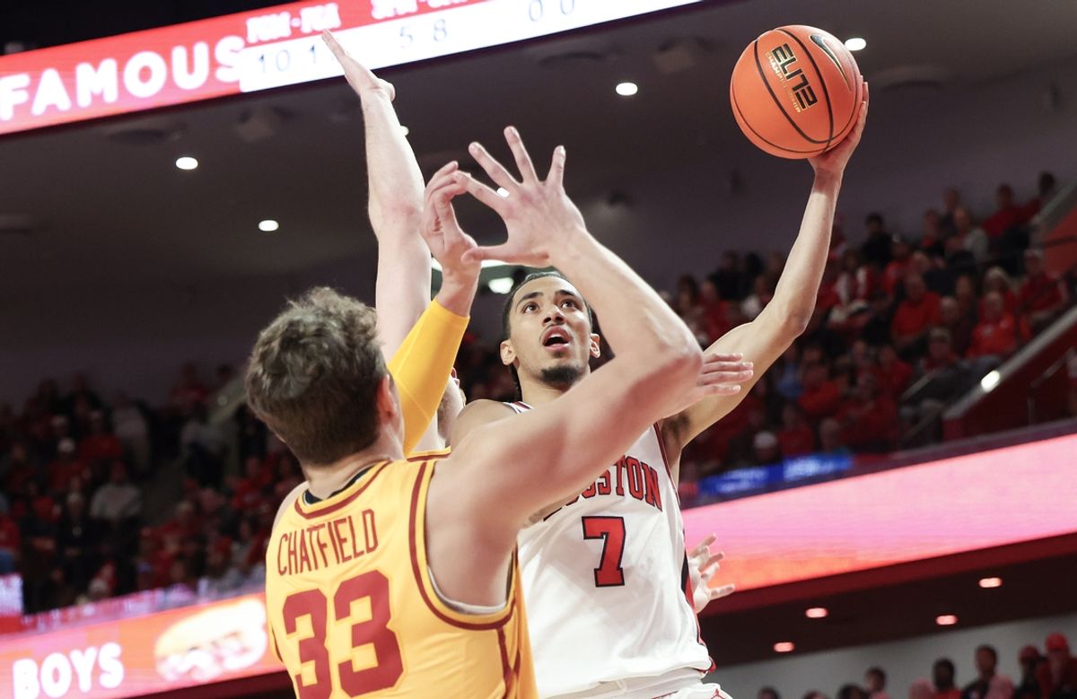 Feb 22, 2025; Houston, Texas, USA; Houston Cougars guard Milos Uzan (7) shoots against Iowa State Cyclones forward Brandton Chatfield (33) in the first half at Fertitta Center. Mandatory Credit: Thomas Shea-Imagn Images