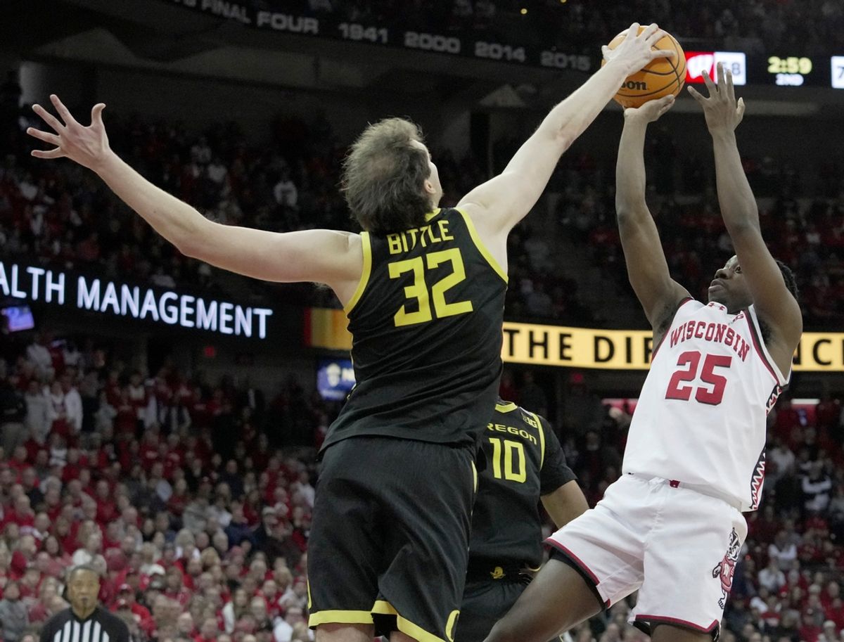 Oregon center Nate Bittle (32) blocks a shot by Wisconsin guard John Blackwell (25) during overtime of their game Saturday, February 22, 2025 at the Kohl Center in Madison, Wisconsin. Oregon beat Wisconsin 77-73 in overtime.