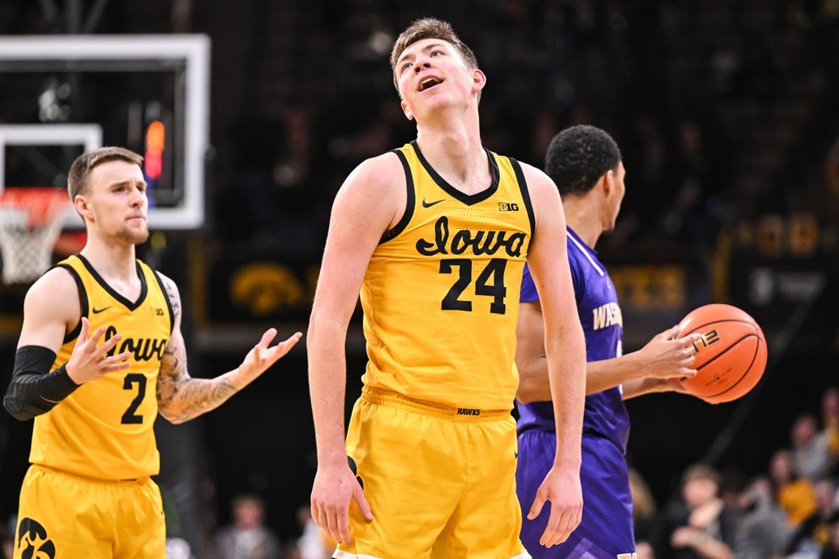 Feb 22, 2025; Iowa City, Iowa, USA; Iowa Hawkeyes forward Pryce Sandfort (24) reacts during the first half against the Washington Huskies as guard Brock Harding (2) looks on at Carver-Hawkeye Arena. Mandatory Credit: Jeffrey Becker-Imagn Images