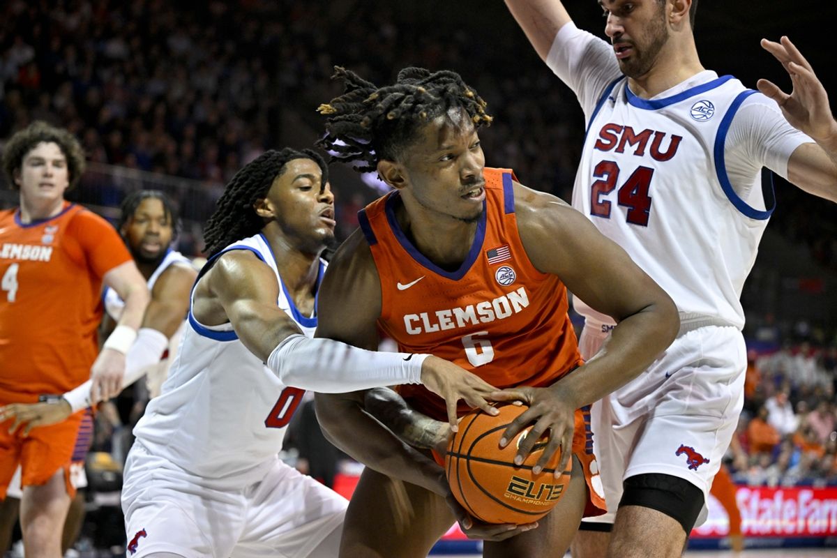 Feb 22, 2025; Dallas, Texas, USA; SMU Mustangs guard AJ George (10) and center Samet Yigitoglu (24) and Clemson Tigers forward Myles Foster (6) battle for control of the ball during the first half at Moody Coliseum. Mandatory Credit: Jerome Miron-Imagn Images