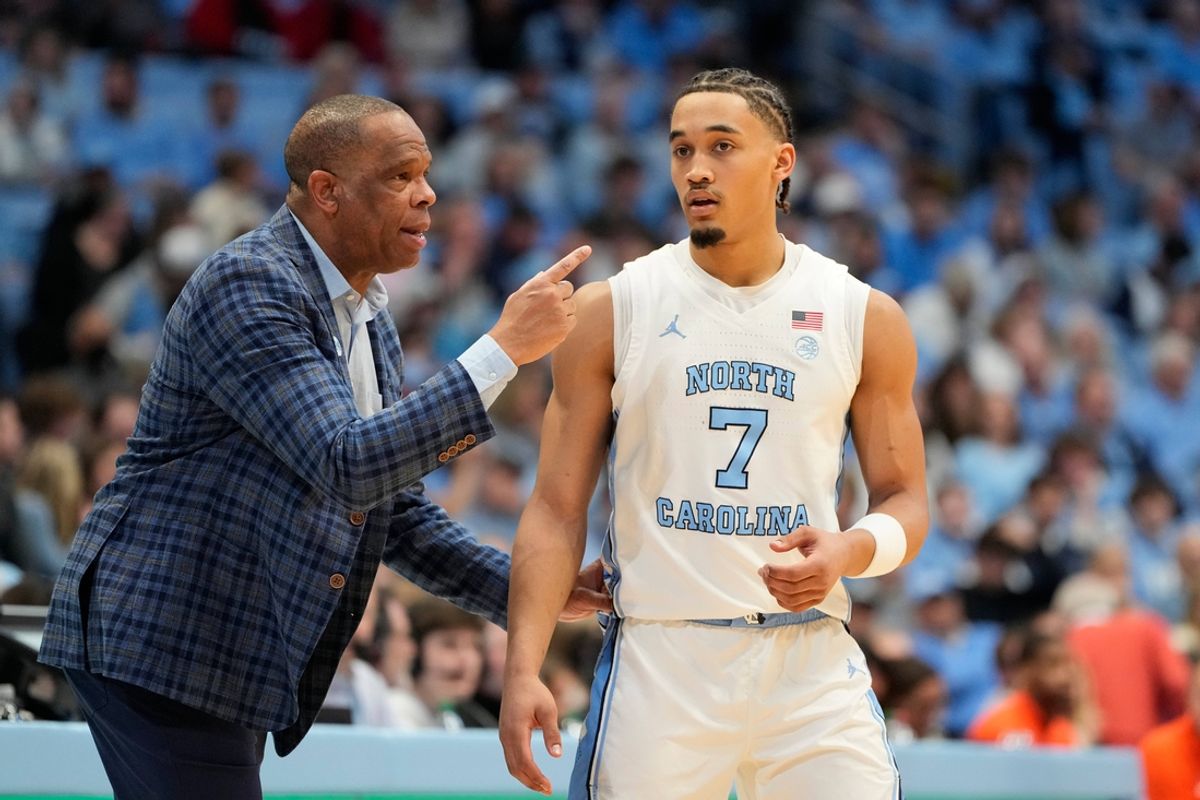 Feb 22, 2025; Chapel Hill, North Carolina, USA; North Carolina Tar Heels head coach Hubert Davis talks to guard Seth Trimble (7) in the first half at Dean E. Smith Center. Mandatory Credit: Bob Donnan-Imagn Images