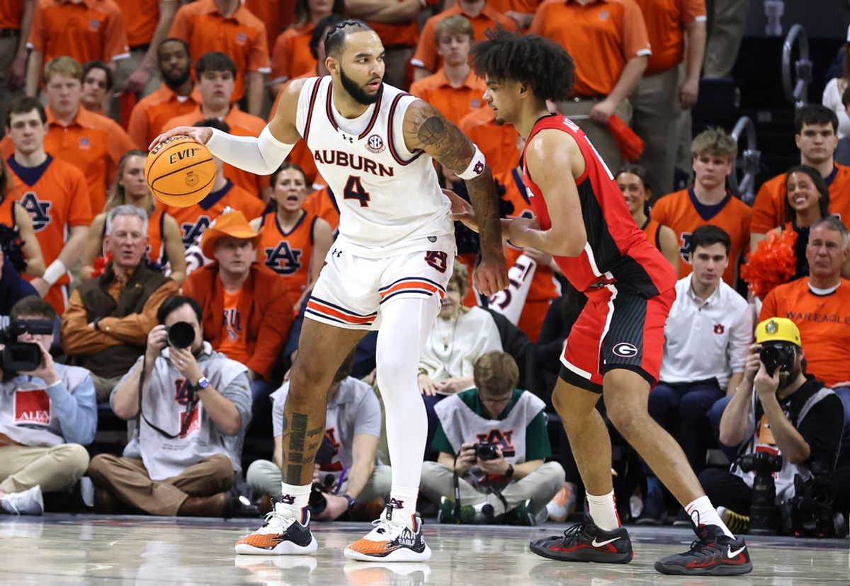 Feb 22, 2025; Auburn, Alabama, USA;  Auburn Tigers forward Johni Broome (4) is pressured by Georgia Bulldogs forward Asa Newell (14) during the first half at Neville Arena. Mandatory Credit: John Reed-Imagn Images