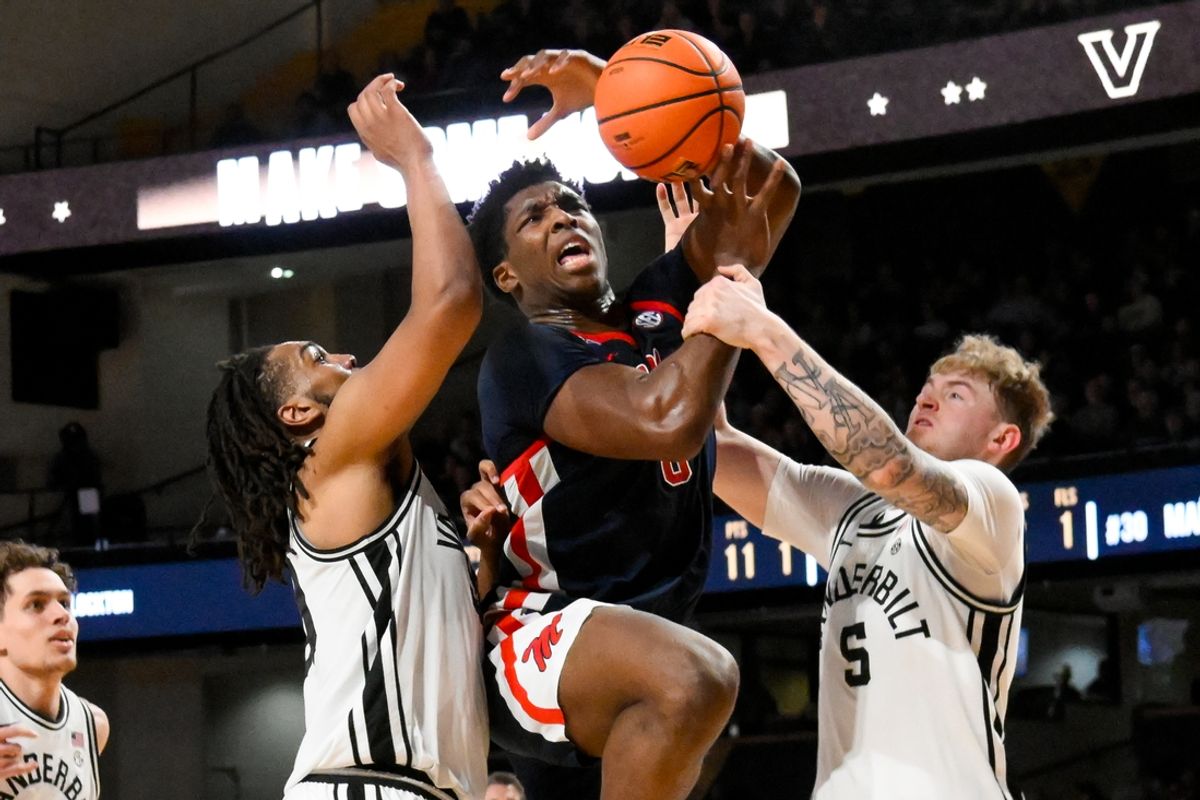 Feb 22, 2025; Nashville, Tennessee, USA; Mississippi Rebels forward Malik Dia (0) gets fouled by Vanderbilt Commodores guard Tyler Nickel (5) and forward Devin McGlockton (99) during the second half at Memorial Gymnasium. Mandatory Credit: Steve Roberts-Imagn Images