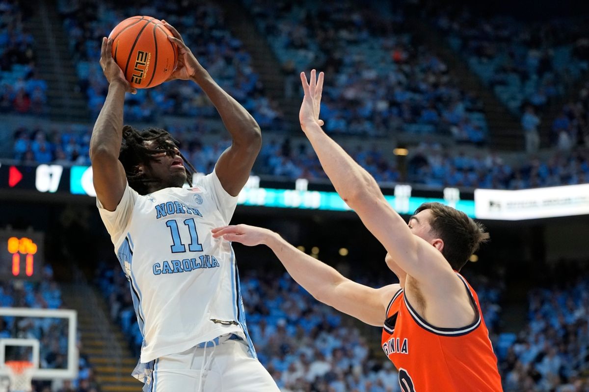 Feb 22, 2025; Chapel Hill, North Carolina, USA; North Carolina Tar Heels guard Ian Jackson (11) shoots as Virginia Cavaliers guard Taine Murray (10) defends in the second half at Dean E. Smith Center. Mandatory Credit: Bob Donnan-Imagn Images