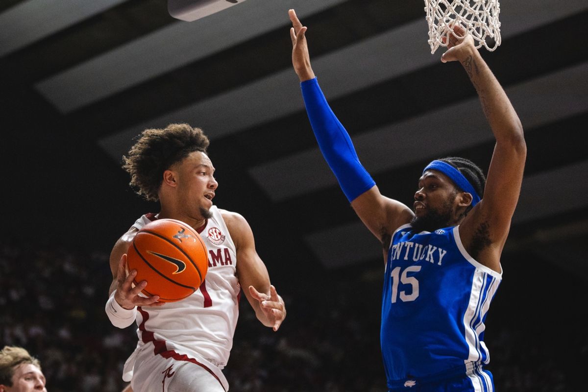 Feb 22, 2025; Tuscaloosa, Alabama, USA; Alabama Crimson Tide guard Mark Sears (1) makes an assist against Kentucky Wildcats forward Ansley Almonor (15) during the first half at Coleman Coliseum. Mandatory Credit: Will McLelland-Imagn Images