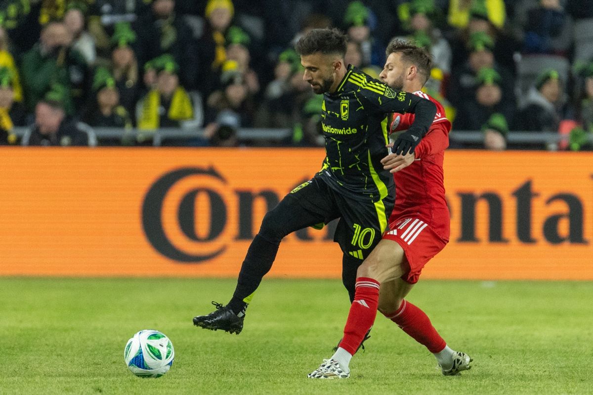 Feb 22, 2025; Columbus, Ohio, USA; Columbus Crew forward Diego Rossi (10) dribbles the ball while Chicago Fire FC midfielder Philip Zinckernagel (11) defends in the first half at Lower.com Field. Mandatory Credit: Trevor Ruszkowski-Imagn Images