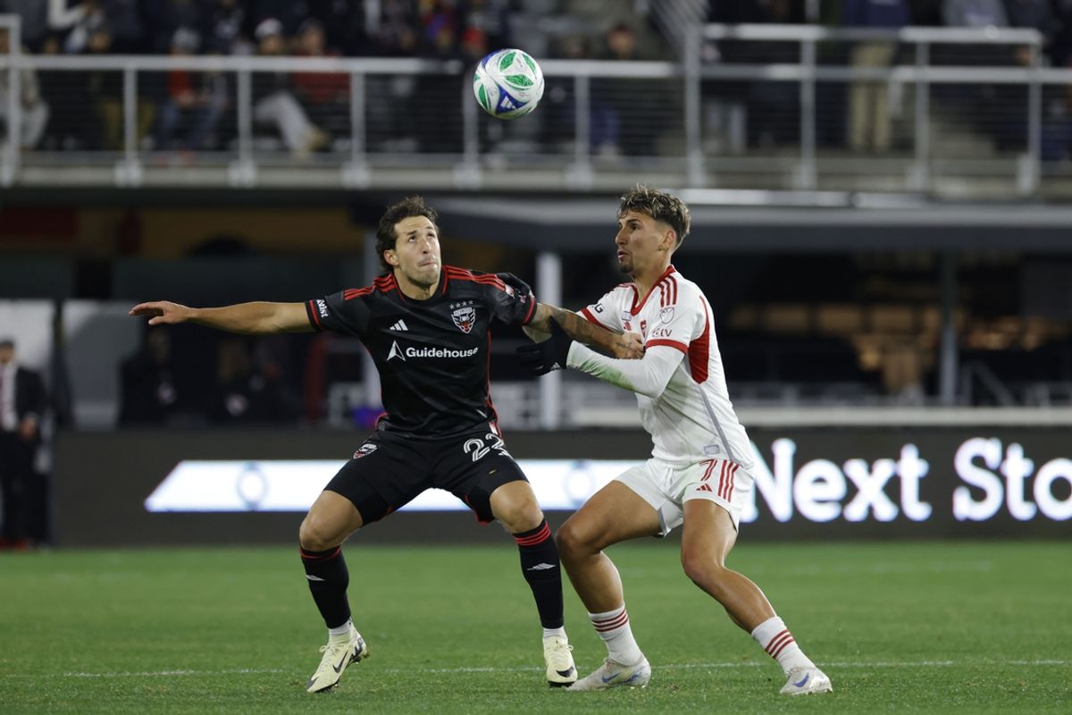 Feb 22, 2025; Washington, District of Columbia, USA; D.C. United defender Aaron Herrera (22) battles for the ball with Toronto FC Theo Corbeanu (7) during the first half at Audi Field. Mandatory Credit: Amber Searls-Imagn Images