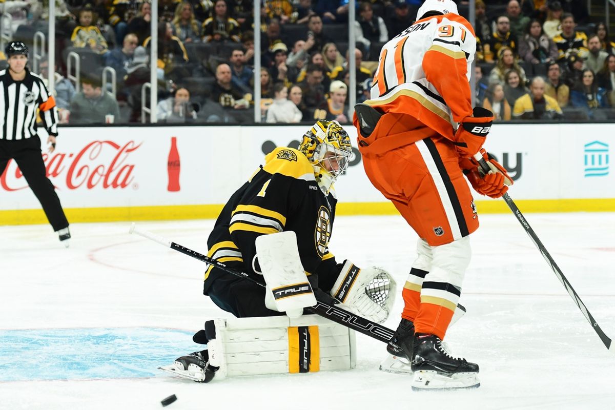Feb 22, 2025; Boston, Massachusetts, USA; Boston Bruins goaltender Jeremy Swayman (1) makes a save in front of Anaheim Ducks center Leo Carlsson (91) during the second period at TD Garden. Mandatory Credit: Bob DeChiara-Imagn Images