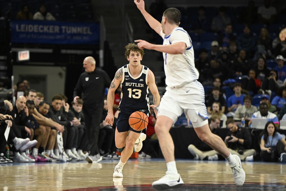 Feb 22, 2025; Chicago, Illinois, USA;  Butler Bulldogs guard Finley Bizjack (13) drives against DePaul Blue Demons forward Troy D'Amico (0) during the first half at Wintrust Arena. Mandatory Credit: Matt Marton-Imagn Images