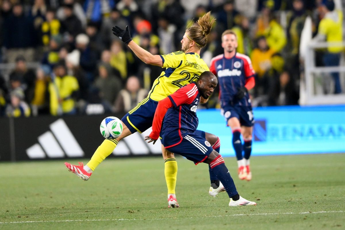 Feb 22, 2025; Nashville, Tennessee, USA;  Nashville SC defender Walker Zimmerman (25) heads the ball over New England Revolution midfielder Alhassan Yusuf (80) during the first half at Geodis Park. Mandatory Credit: Steve Roberts-Imagn Images