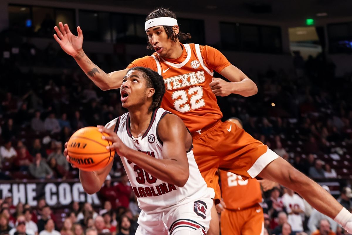 Feb 22, 2025; Columbia, South Carolina, USA; South Carolina Gamecocks forward Collin Murray-Boyles (30) is fouled by Texas Longhorns forward Devon Pryor (22) while making a basket in the first half at Colonial Life Arena. Mandatory Credit: Jeff Blake-Imagn Images
