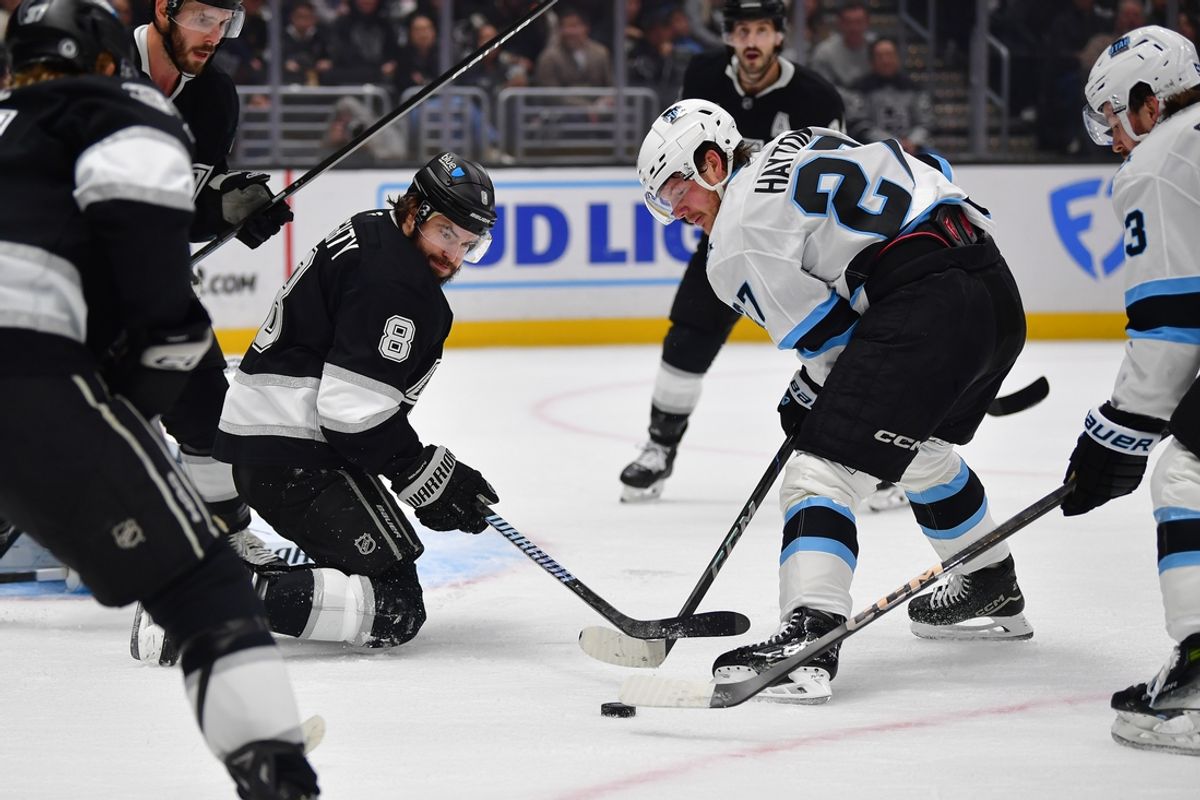 Feb 22, 2025; Los Angeles, California, USA; Los Angeles Kings defenseman Drew Doughty (8) helps defend the goal against Utah Hockey Club center Barrett Hayton (27) during the first period  at Crypto.com Arena. Mandatory Credit: Gary A. Vasquez-Imagn Images