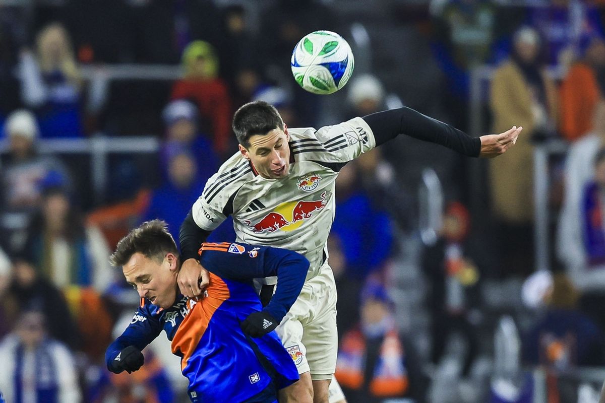 Feb 22, 2025; Cincinnati, Ohio, USA; New York Red Bulls defender Sean Nealis (15) heads the ball against FC Cincinnati forward Corey Baird (11) in the second half at TQL Stadium. Mandatory Credit: Katie Stratman-Imagn Images