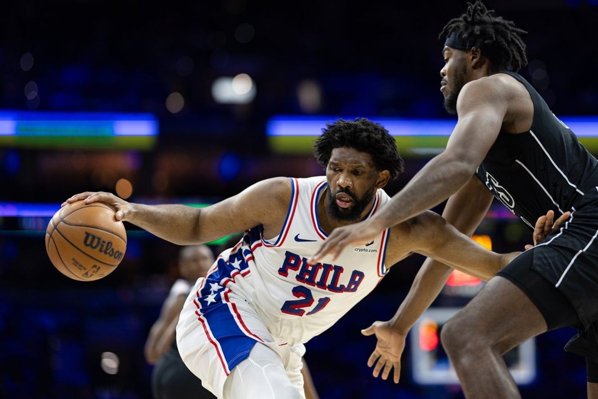 Feb 22, 2025; Philadelphia, Pennsylvania, USA; Philadelphia 76ers center Joel Embiid (21) controls the ball against Brooklyn Nets center Day'Ron Sharpe (20) during the third quarter at Wells Fargo Center. Mandatory Credit: Bill Streicher-Imagn Images