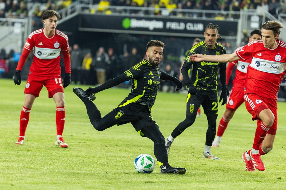 Feb 22, 2025; Columbus, Ohio, USA; Columbus Crew forward Diego Rossi (10) kicks the ball while Chicago Fire FC defender Jack Elliot (3) defends in the second half at Lower.com Field. Mandatory Credit: Trevor Ruszkowski-Imagn Images